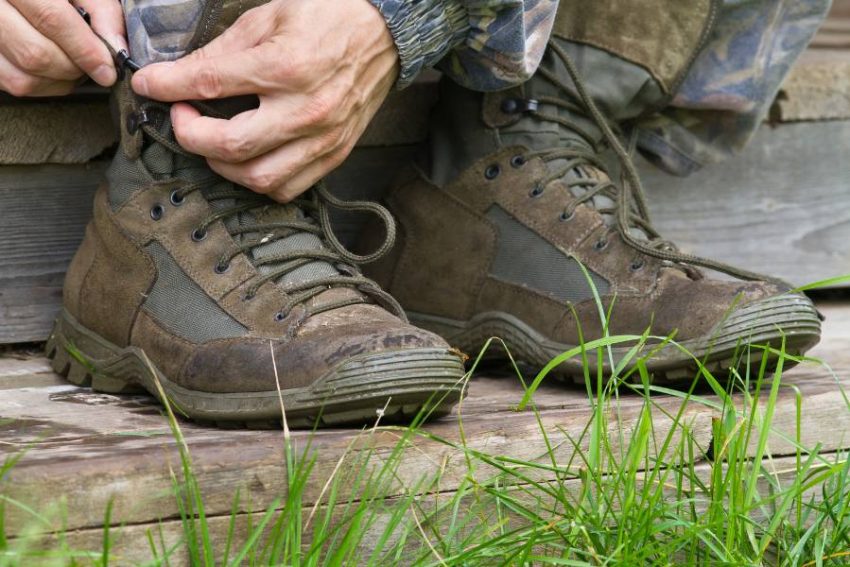 Closeup of a man lacing up hiking boots
