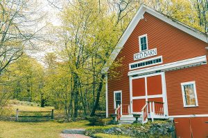 Red Barn surrounded by green trees
