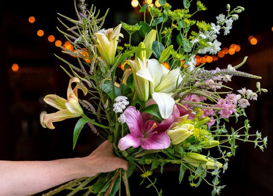 Someone holding a bouquet of flowers