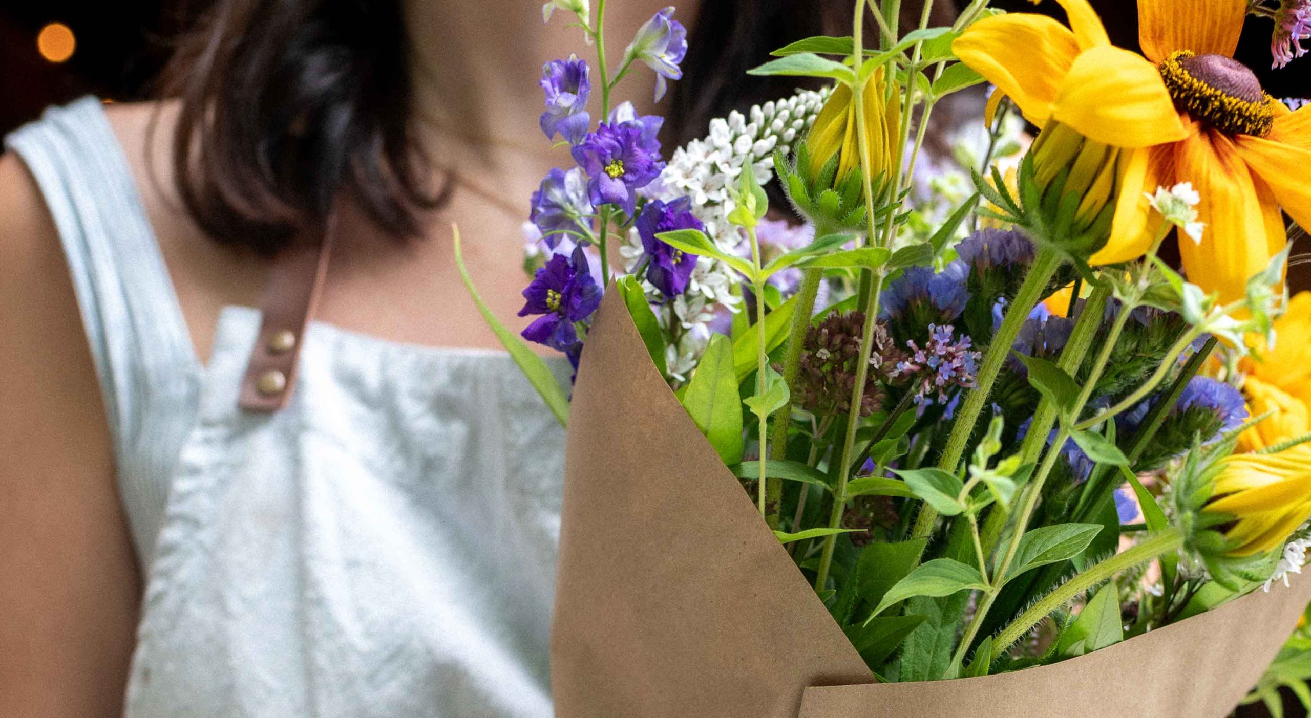 Woman holding a bouquet of flowers at Barn INN Bloom gift & flower shop